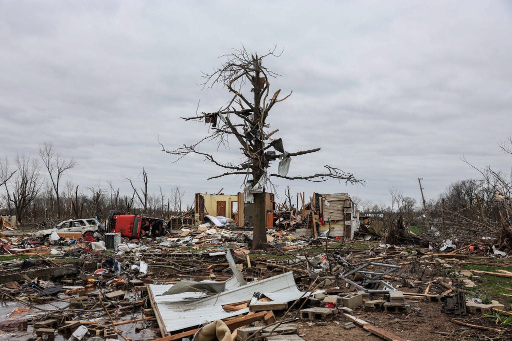 A tree stands mangled above debris after a tornado in Sullivan, Indiana. Three people were declared dead, and 8 others were injured, as the search and rescue operation continued Saturday afternoon. The severe storm that created the tornado struck Friday, March 31, 2023, and damaged about 150 homes and structures in Sullivan. (Photo by Jeremy Hogan/SOPA Images/LightRocket via Getty Images)