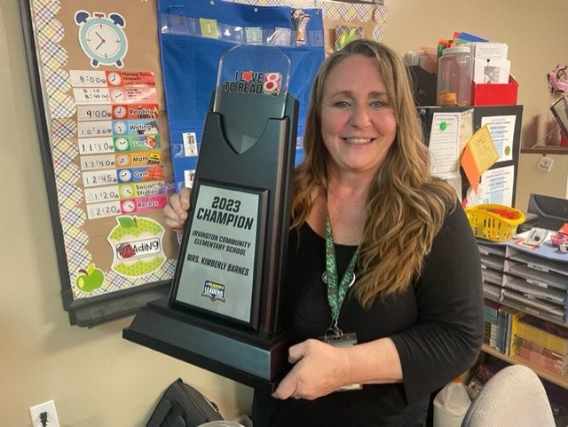 Mrs. Kimberly Barnes with the I Love to Read trophy on April 5, 2023. (WISH Photo/Hanna Mordoh)