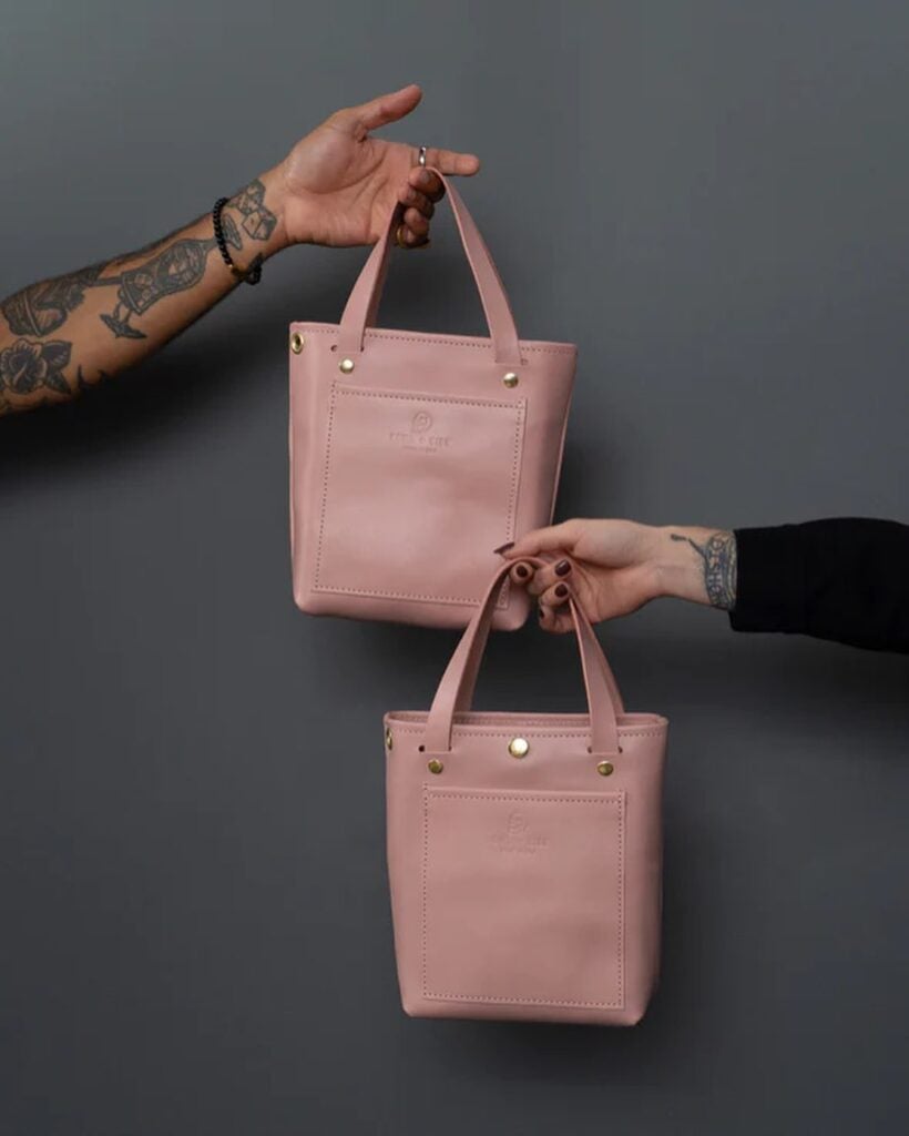Howl + Hide Blush collection hands of woman and man only holding totes