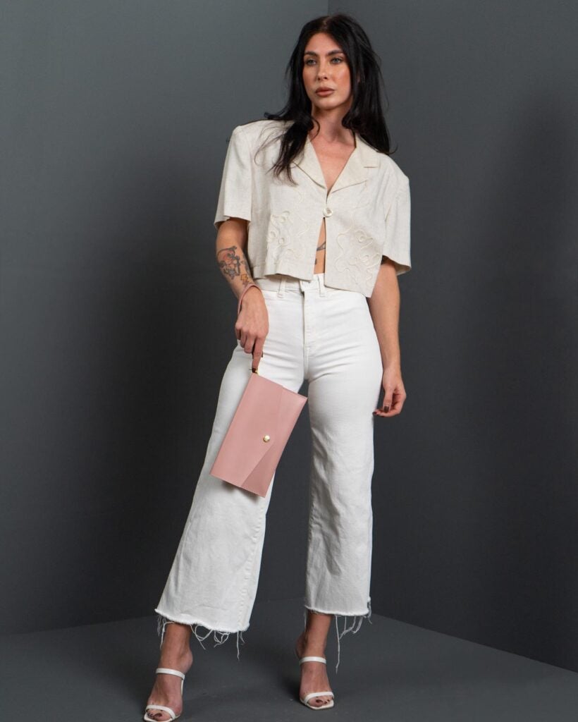 Howl + Hide Blush collection woman holding clutch