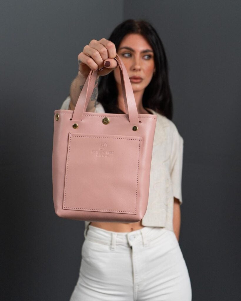 Howl + Hide Blush collection woman holding up tote