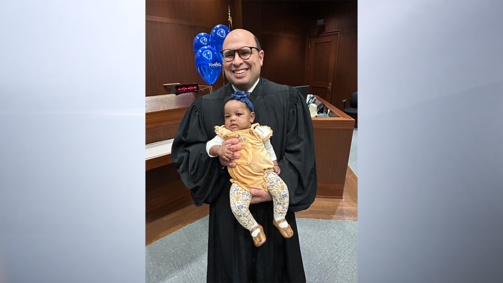 Hamilton Superior Court 5 Judge David Najjar and the newly adopted baby who was surrendered in August at Carmel Fire Station No. 345. (Provided Photo/The Reporter)