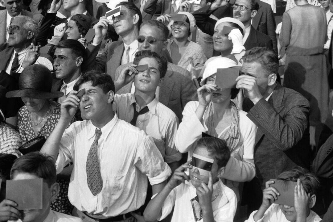 Indiana's total solar eclipse is less than 50 days away! Here's a look at how people enjoyed total solar eclipses in years past. Eclipse watchers squint through protective filters as they view an eclipse of the sun from the top deck of New York's Empire State Building in New York on Wednesday, Aug. 31, 1932. (AP Photo/File, File)