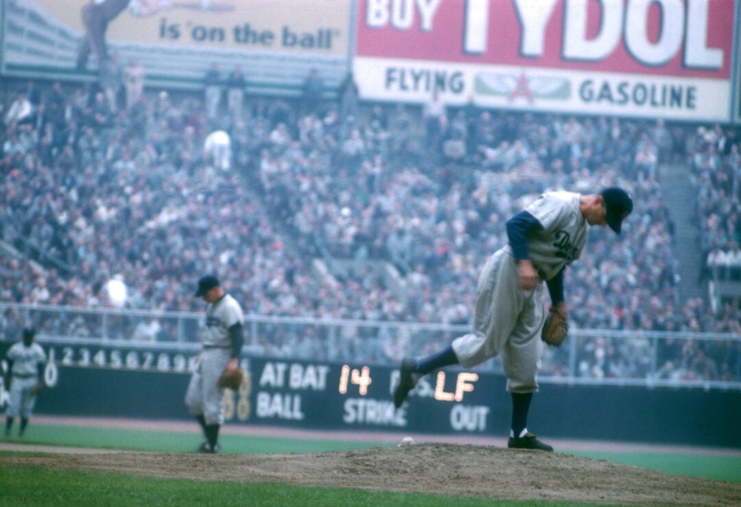 Pitcher Carl Erskine #17 of the Brooklyn Dodgers kicks at the rubber before facing Gene Woodling #14 of the New York Yankees (not pictured) during Game 6 of the 1953 World Series on October 5, 1953 at Yankee Stadium in the Bronx, New York. (Photo by Hy Peskin/Getty Images)